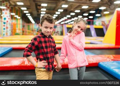 Playful boy and girl in childrens entertainment center. Happy childhood