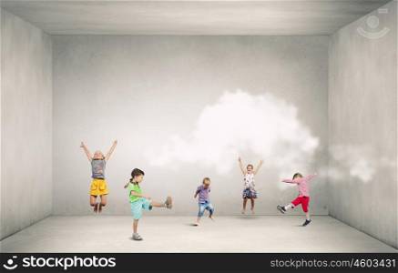 Playful children catch balloons. Group of happy children playing on concrete background