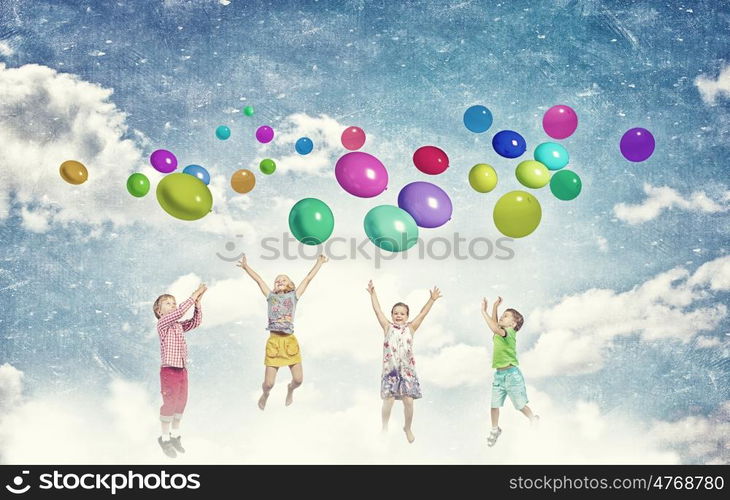 Playful children catch balloons. Group of happy children playing with colorful balloons