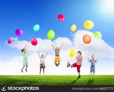 Playful children catch balloons. Group of happy children playing with colorful balloons