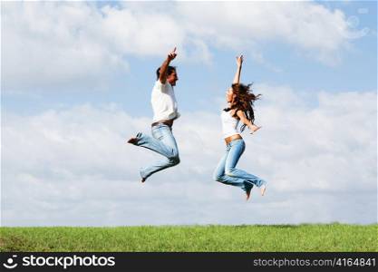 Playful couple jumping high in air