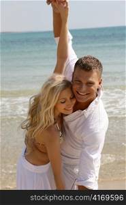 Playful couple on the beach