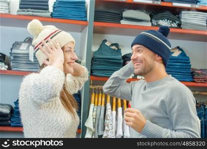Playful couple trying on hats