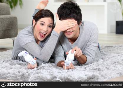 Playful couple with video games