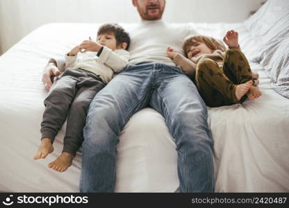 playful father bed with sons