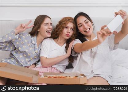 playful girlfriends taking selfie