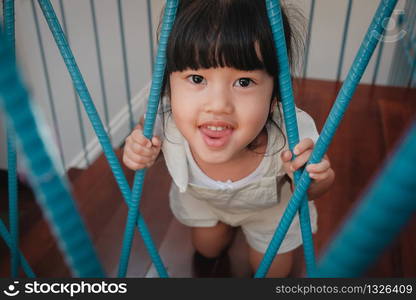 Playful Kids. Childhood Concept. Little Cute 3-4 Years Old Girl in Happiness Moment. Children Playing in House. Looking at Camera