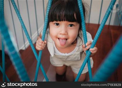 Playful Kids. Childhood Concept. Little Cute 3-4 Years Old Girl in Happiness Moment. Children Playing in House. Looking at Camera