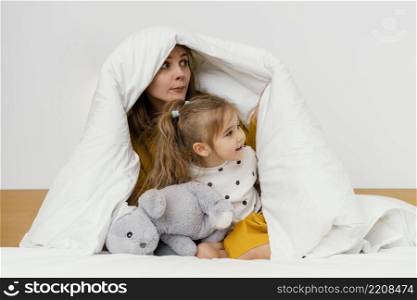 playful mother kid hiding blanket