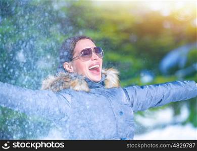 Playful woman having fun on winter park, throwing snow, enjoying wintertime nature, active lifestyle, happiness concept&#xA;