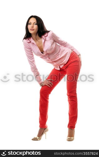 Playful young brunette in red jeans. Isolated