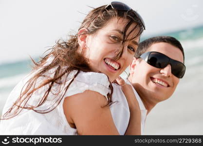 playful young couple look back and smiling on the beach,outdoor