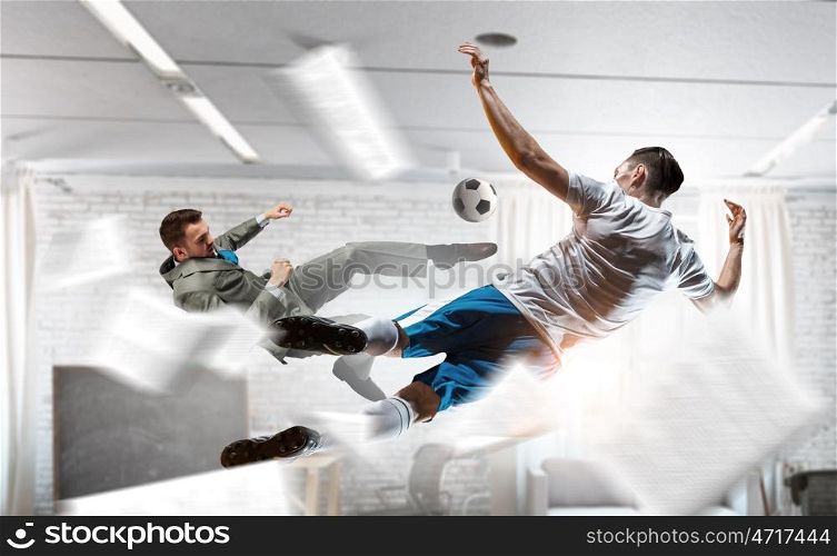 Playing ball in office. Emotional businessman playing soccer ball in modern office
