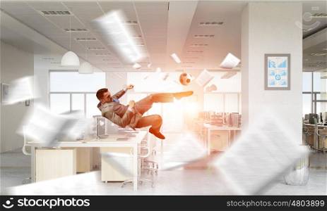 Playing ball in office. Emotional businessman playing soccer ball in modern office