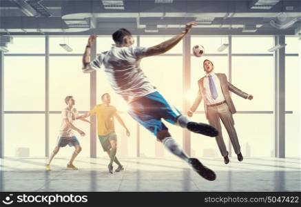 Playing ball in office. Players and businessman playing soccer ball in modern office