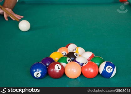 Playing billiards with balls on a green felt table