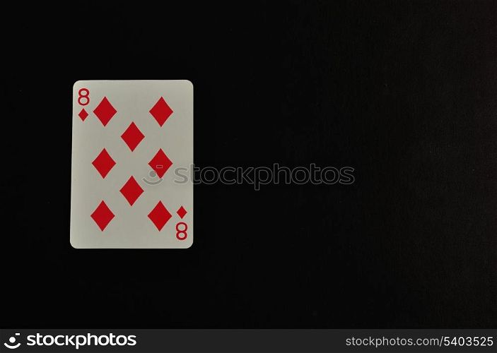 Playing card. Eight of diamond isolated on a black background
