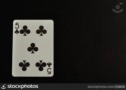 Playing card. Five of clovers isolated on a black background