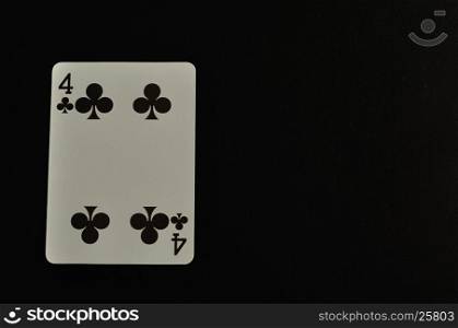 Playing card. Four of clovers isolated on a black background