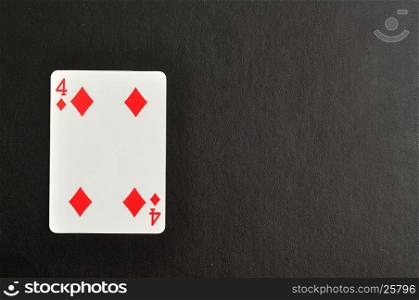 Playing card. Four of diamond isolated on a black background