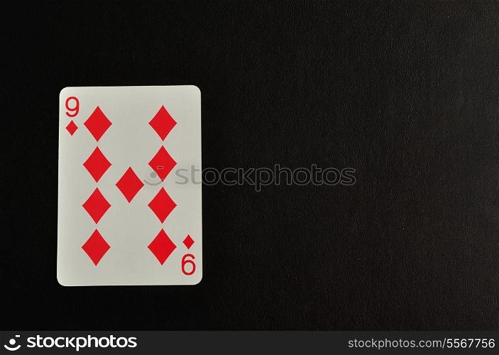 Playing card. Nine of diamond isolated on a black background