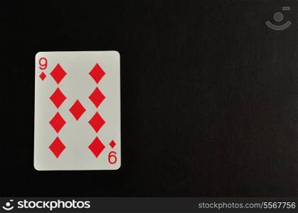 Playing card. Nine of diamond isolated on a black background