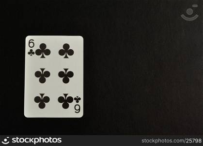 Playing card. Six of clovers isolated on a black background
