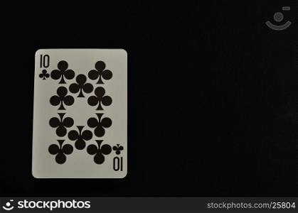 Playing card. Ten of clovers isolated on a black background