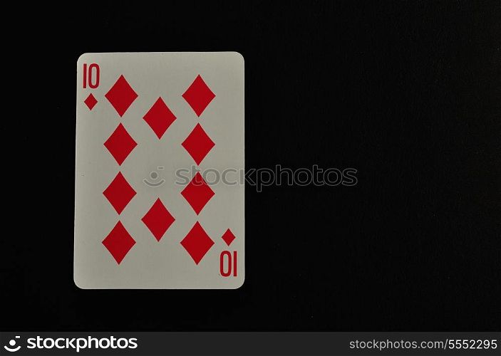 Playing card. Ten of diamond isolated on a black background