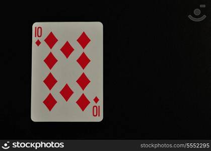 Playing card. Ten of diamond isolated on a black background