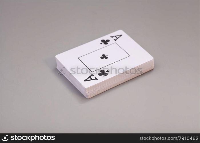 Playing cards with ace of clubs isolated on gray background
