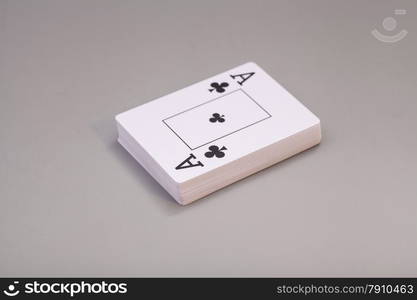 Playing cards with ace of clubs isolated on gray background