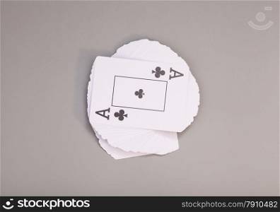 Playing cards with ace of clubs isolated on gray background