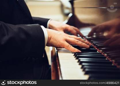 Playing classic piano. Professional musician pianist hands on piano keys.