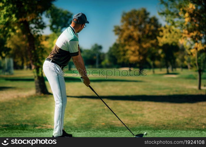 Playing golf. Golfer getting ready for the shot