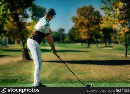 Playing golf. Golfer getting ready for the shot