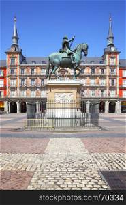 Plaza Mayor (Main Square) with statue of King Philip III (created in 1616 by Jean Boulogne and Pietro Tacca) in Madrid, Spain