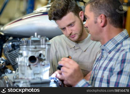 pleasant concentrated engineeers examining robot