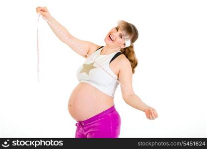 Pleased beautiful pregnant woman holding measure tape in hands isolated on white&#xA;