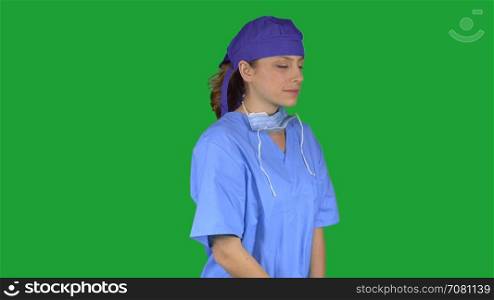 Pleased female medical professional w/ hand on chin (Green Key)