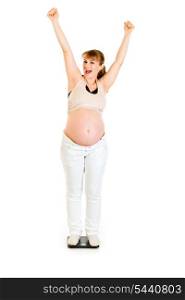 Pleased pregnant woman standing on weight scale isolated on white&#xA;