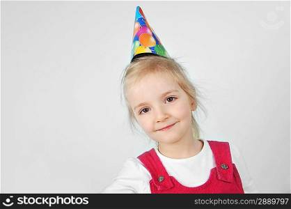 Pleasure and happiness little girl with birthday hat