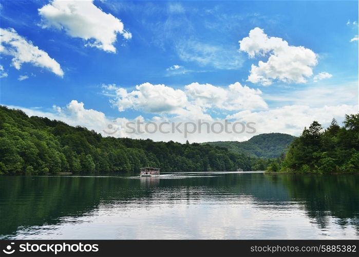 pleasure boat floats along forest river