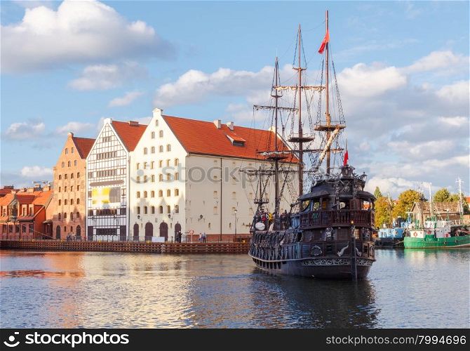 Pleasure craft and colorful facades of the houses on the central waterfront in Gdansk.. Gdansk. Central embankment.