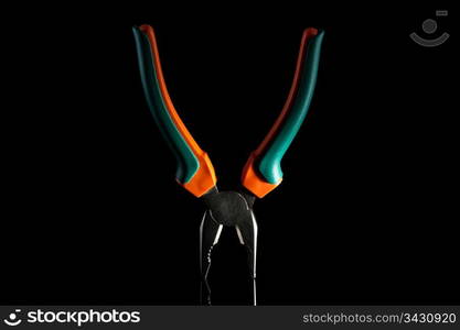 pliers with rubbed grips on black bachground