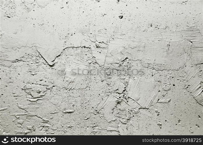 Plot of gray wall covered with rough plaster