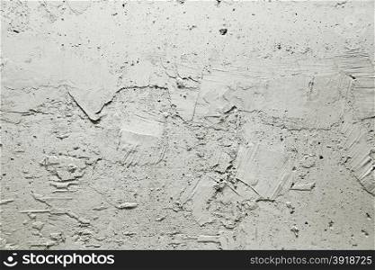 Plot of gray wall covered with rough plaster