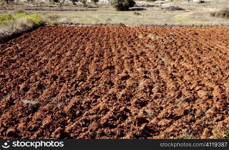 Plowed field in red clay, spain