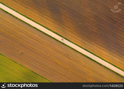 Plowed field in rural area. Landscape of agricultural fields. Aerial view. Plowed field in rural area. Landscape of agricultural fields