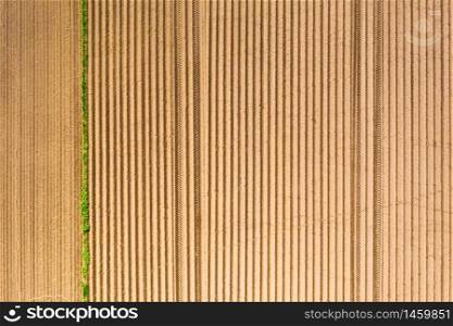 Plowed field in rural area. Landscape of agricultural fields. Aerial view. Plowed field in rural area. Landscape of agricultural fields